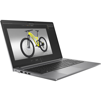 Angled view of a silver HP ZBOOK Power G10 laptop open on a white background, displaying vibrant 15.6” image editing software with a yellow mountain bike on screen. This refurbished laptop features an Intel Core i7-13800H processor, 32GB DDR4 RAM, 1TB NVMe SSD, and NVIDIA RTX A1000 6GB graphics. - View 4