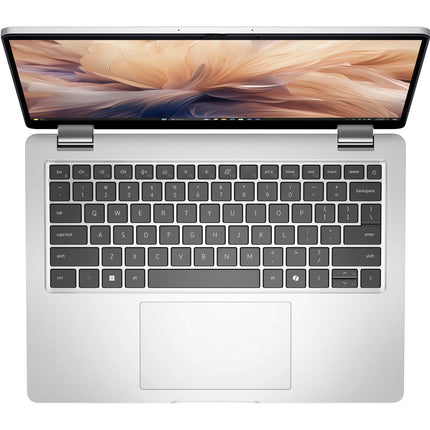 Top view of a silver DELL Pro 14 Plus PB14250 laptop with an Intel Core Ultra 7 processor, featuring a spacious trackpad, black chiclet keyboard, and a 14″ FHD screen displaying abstract beige and orange swirls. - View 5