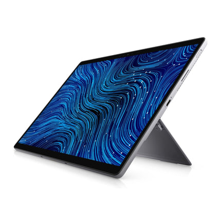 Angled view of refurbished Dell Latitude 7320 Detachable tablet propped on its kickstand, blue wave wallpaper on display. - View 6