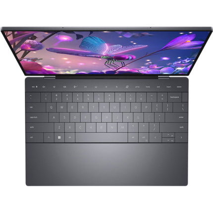 Top-down view of a refurbished Dell XPS 13 9320 featuring a backlit keyboard and a screen displaying colorful butterfly and floral wallpaper. - View 5