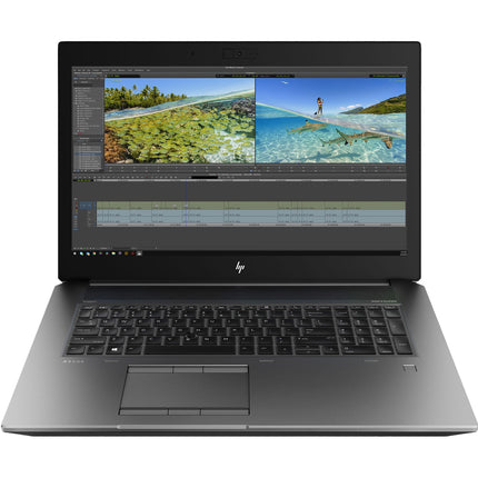 Angled view of a refurbished HP ZBook 17 G6 laptop by HP, displaying vivid beach and underwater video editing scenes on its 15.6-inch screen, set against a white background; equipped with an Intel Core i7-9750H processor, 32GB DDR4 RAM, 512GB NVMe SSD, and Nvidia Quadro T1000 4GB graphics card. - View 1