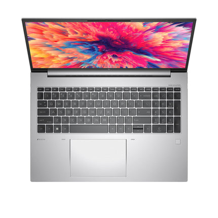 Top view of a refurbished silver HP ZBOOK FIREFLY 16 G9 laptop with keyboard, touchpad, and hinge visible, specs listed. - View 4